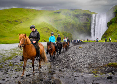 Riders near Skógafoss falls