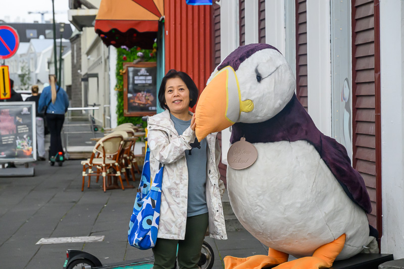 woman with giant toy puffin bird